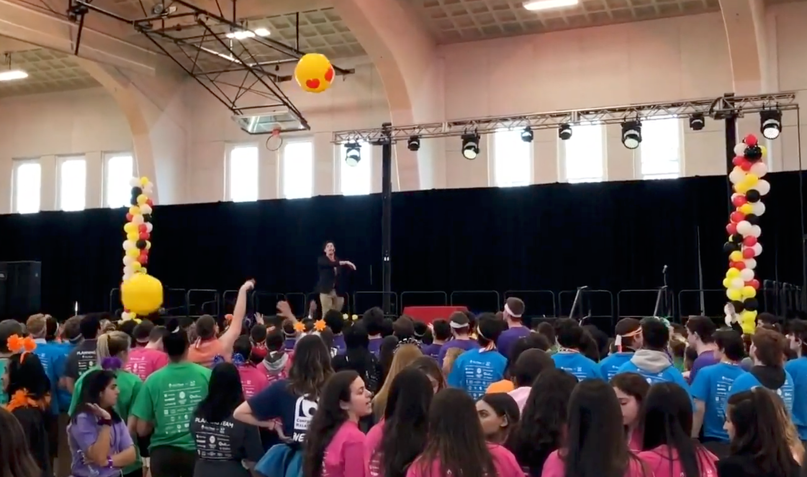 Adam Stone Performing a Mentalism Show on Stage at Terp Thon at the University of Maryland Hitting Large Emoji Beach Balls into the Audience to Select Random Volunteers