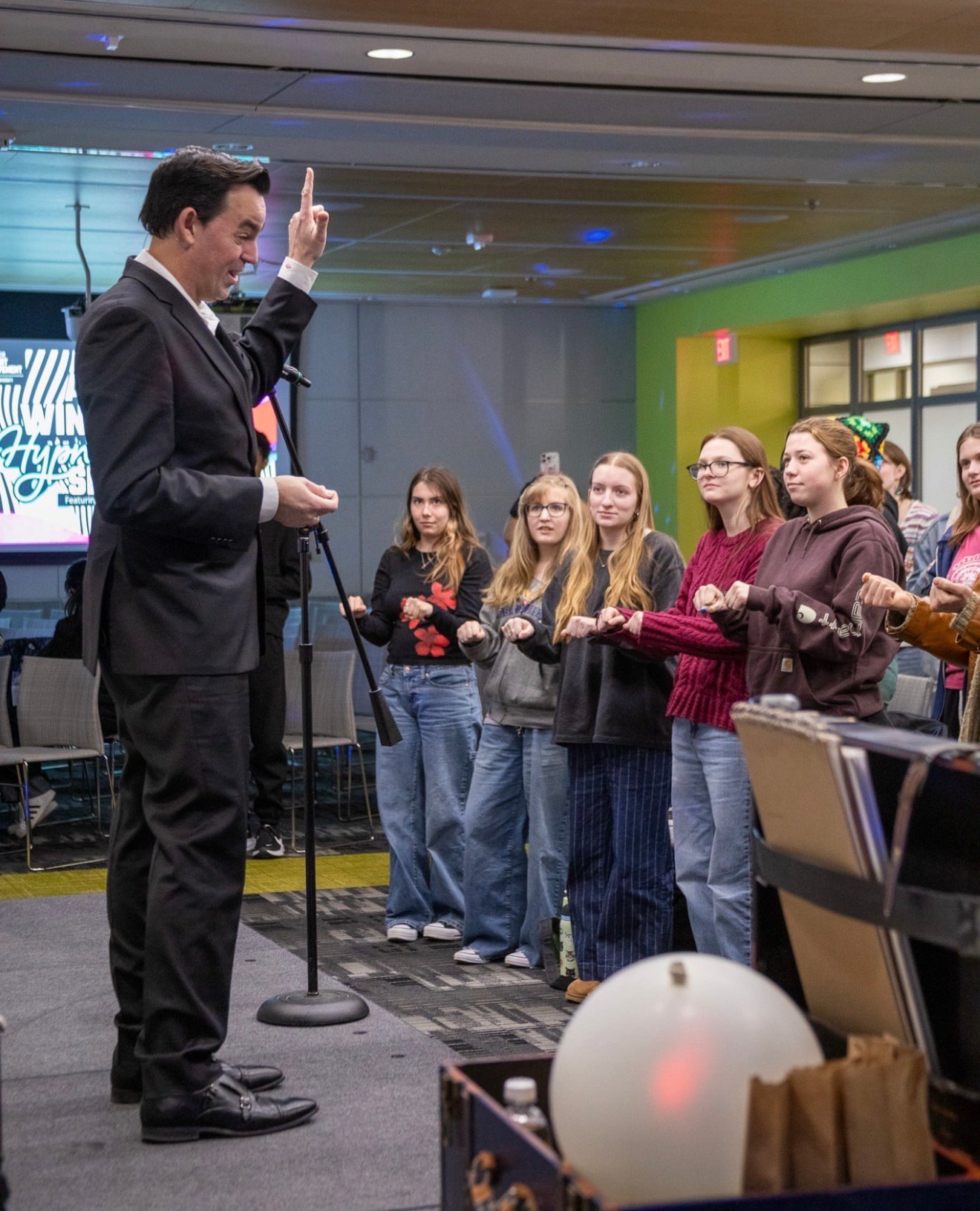 Adam Stone Performing a Mentalism Show on Stage at the University of Virginia with the Entire Audience Standing and Holding Their Hands Closed in Front of Them